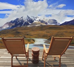 Pleasant holiday. Wooden chairs in the park Torres del Paine. Chile. On the horizon is visible