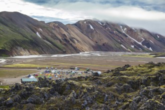 The valley is large tourist camp. Pink and green rhyolite mountains surround the flat valley of the