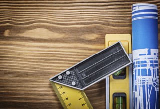 Blue construction drawing level try square on wooden board
