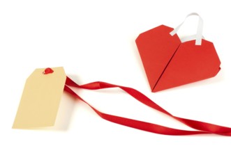 Heart made ??of curled red paper and label. White isolated