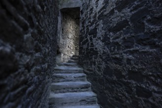 Conwy Castle, medieval stone staircase of the castle winds through narrow, dark and historic