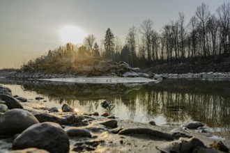 Sunset by the river with spectacular reflections and bare trees, Saalach, Austria, Europe