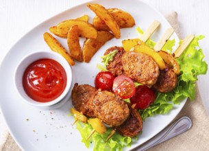 Meatballs skewers of tomato, paprika and baked potato quarters
