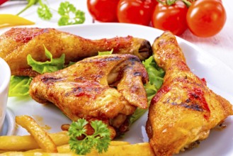 Grilled chicken wings, legs, chips and vegetables