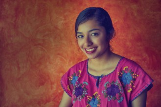 Mexican woman with mayan dress latin ethnicity on orange background