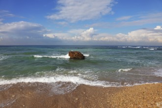 Huge stone in surf waves. Picturesque coast Mediterranean sea, Israel, Asia