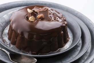 Chocolate pudding with chocolate dressing on a plate