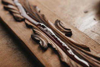 Close-up of varnish applied on carved wood, enhancing its intricate patterns