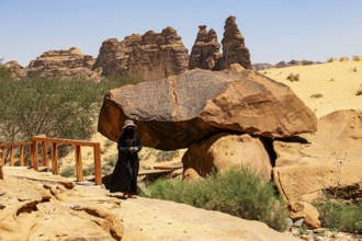 Guide in Jebel or Jabal Ikmah shows large open library, rock bands with petroglyphs, rock carvings