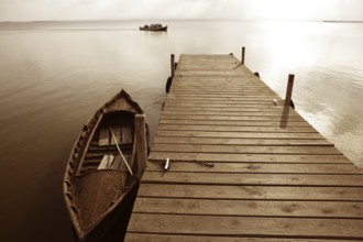 Albufera lake wetlands pier with boat in Valencia Spain