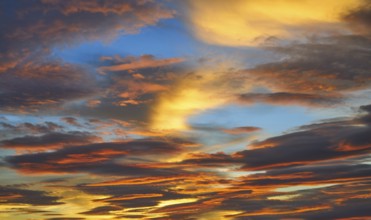 Sunset sky clouds in orange and blue background