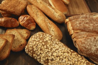 Varied bread still life over dark wood background