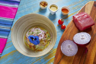 Fish ceviche latin preuvian recipe on bowl with pansy flower