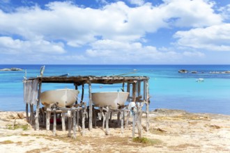 Beached boats in Formentera Els Pujols beach with turquoise water