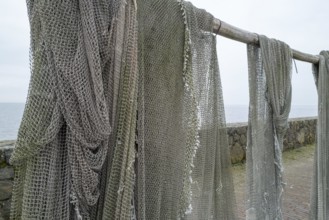 Fishing nets to dry on the road by the sea