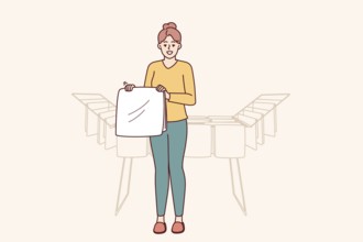 Woman housewife stands near dryer with clean towels doing household chores to create comfort in