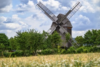 A view of a beautiful windmill in Thuringia Germany in a natural setting and an eye catcher for