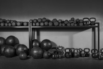 Kettlebells dumbbells and weighted slam balls weight training equipment at gym
