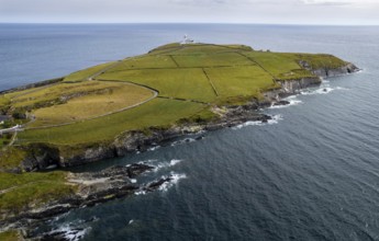 Drone aerial seascape of galley head lighthouse. Dundeady headland island cork county ireland