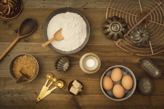 Collection of ingredients and utensils for baking on a dark wooden table