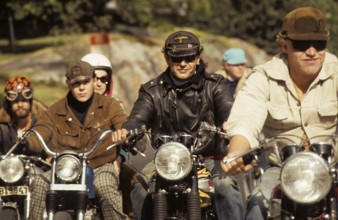 In the 1960s. Motorcyclists on the road together. Cool and trendy looking riding thir bikes. The