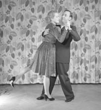 Learning to dance in the 1940s. A couple is dancing together. An instructiv image on how to