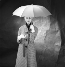 1950s woman with umbrella. A young woman is holding an umbrella. 1958. Kristoffersson ref DB75-6