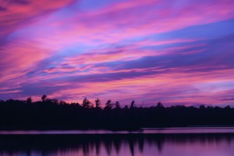 Vibrant colours start to fill the sky as dusk falls over the Kawartha cottage country region