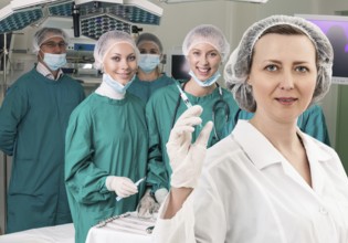 Adult female anesthetist with syringe on the surgery teem background