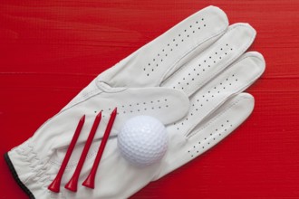 Golf equipments on the wooden red table