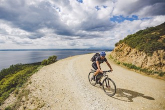 Young guy riding a mountain bike on a bicycle route in Spain. Athlete on a mountain bike rides