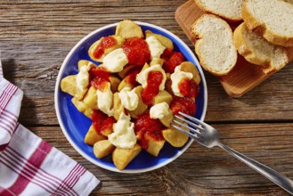 Tapas Patatas Bravas potatoe fries with tomato and mayonaise from Spain