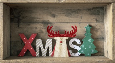 A wooden reindeer with xmas text in a wooden box Christmas symbols decoration