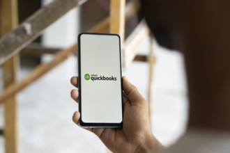 Intuit quickbooks logo is displayed on smartphone. QuickBooks is an accounting software.