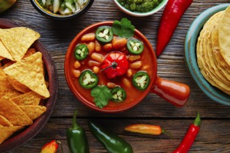 Frijoles charros mexican beans with chili pepper sides and tortillas