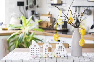 Key to house of cozy home with Easter decor with rabbit and eggs on table of kitchen. Building,