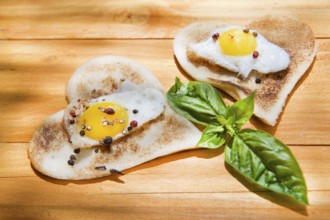 Breakfast of toast and eggs in the shape of heart