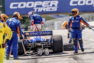 SCOTT DIXON (9) of Auckland, New Zealand comes down pit road after exiting early from Honda Indy