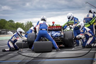 LINUS LUNDQVIST (R) (8) of Stockholm, Sweden comes down pit road for service during the XPEL Grand