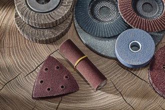 Abrasive Wheels And Papers On Wood Background