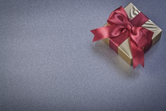 Wrapped present box on grey background holidays concept