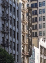 A picture of the sign and fire escape of the 527 West 7th Street building