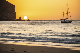 Sunrise during a storm, Calima. A haze-covered horizon turns orange as the sun rises as a ball. A