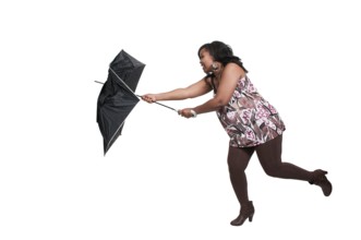 A beautiful woman holding a colorful umbrella in the wind