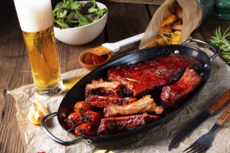 Grilled ribs in a spicy marinade with salad and vegetables