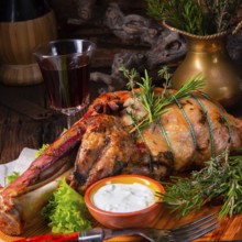 Grilled shoulder of lamb braised in the oven with rosemary