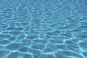 Swimming pool water sun reflection background. Ripple Water