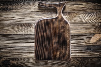 Wooden kitchen utencil cutting board on vintage wood