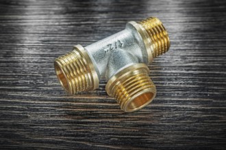 T-tube pipe connector on vintage wooden board