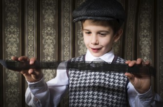 Child considered analog photographic film. Vintage clothes and background
